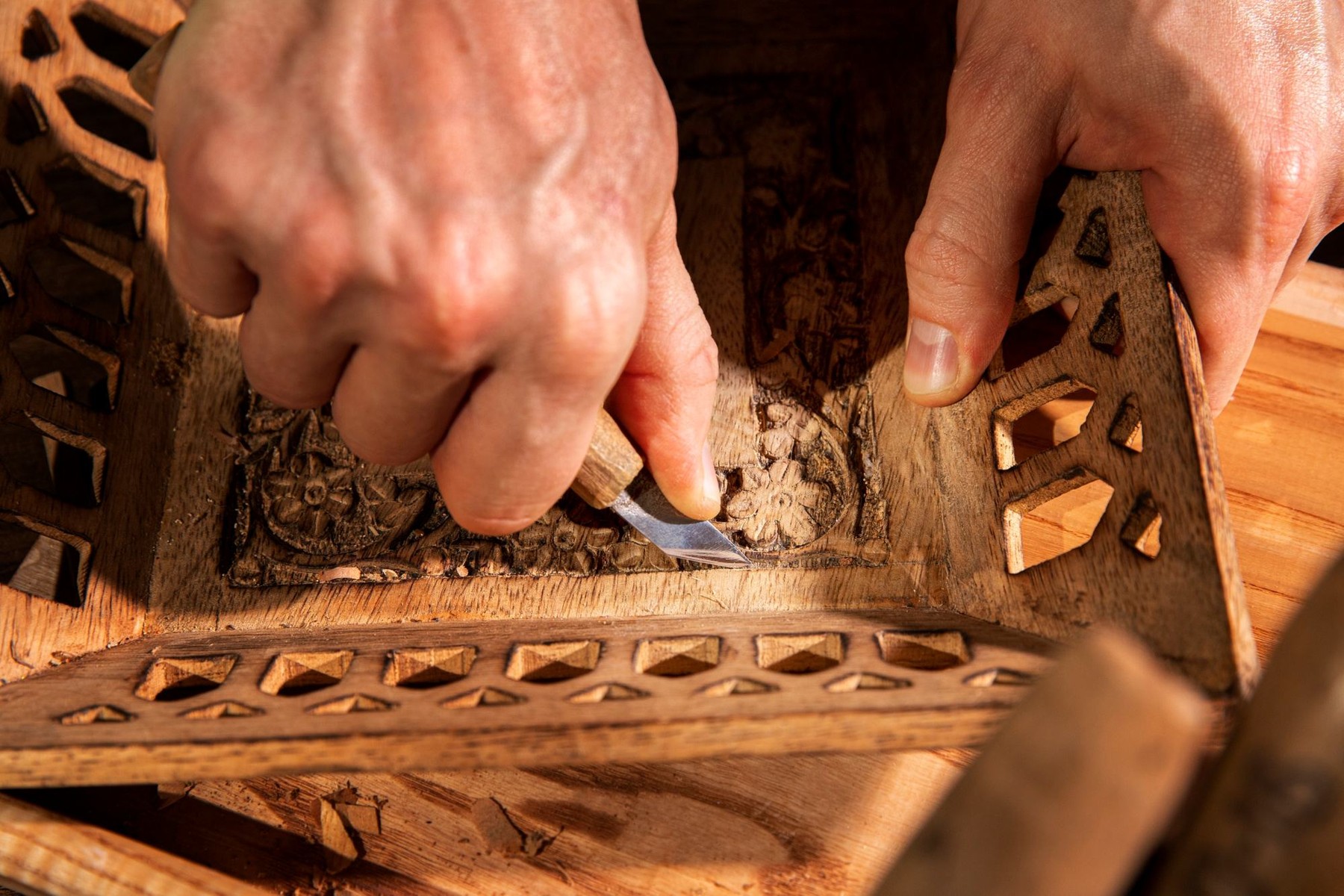 An artisan carving wood